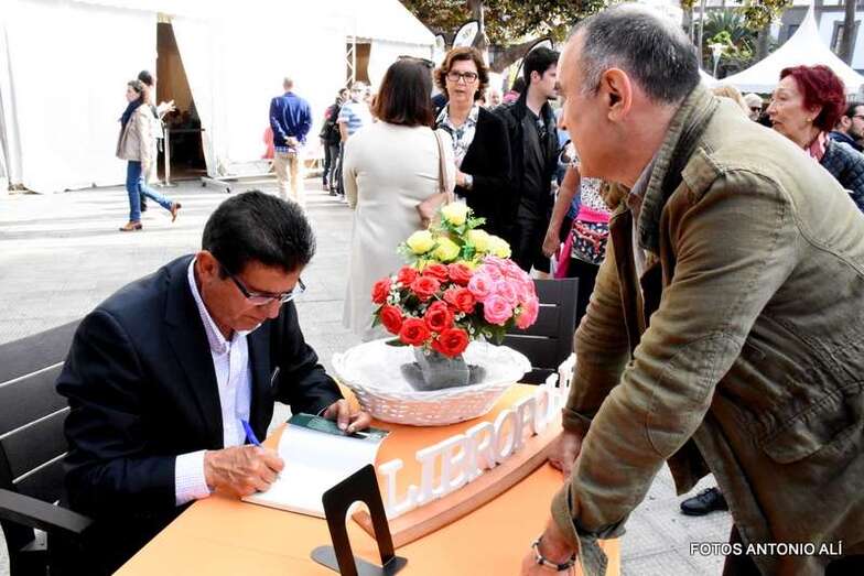 El historiador Manuel Lobo Cabrera firma uno de sus libros en la feria (Foto Antonio Alí)